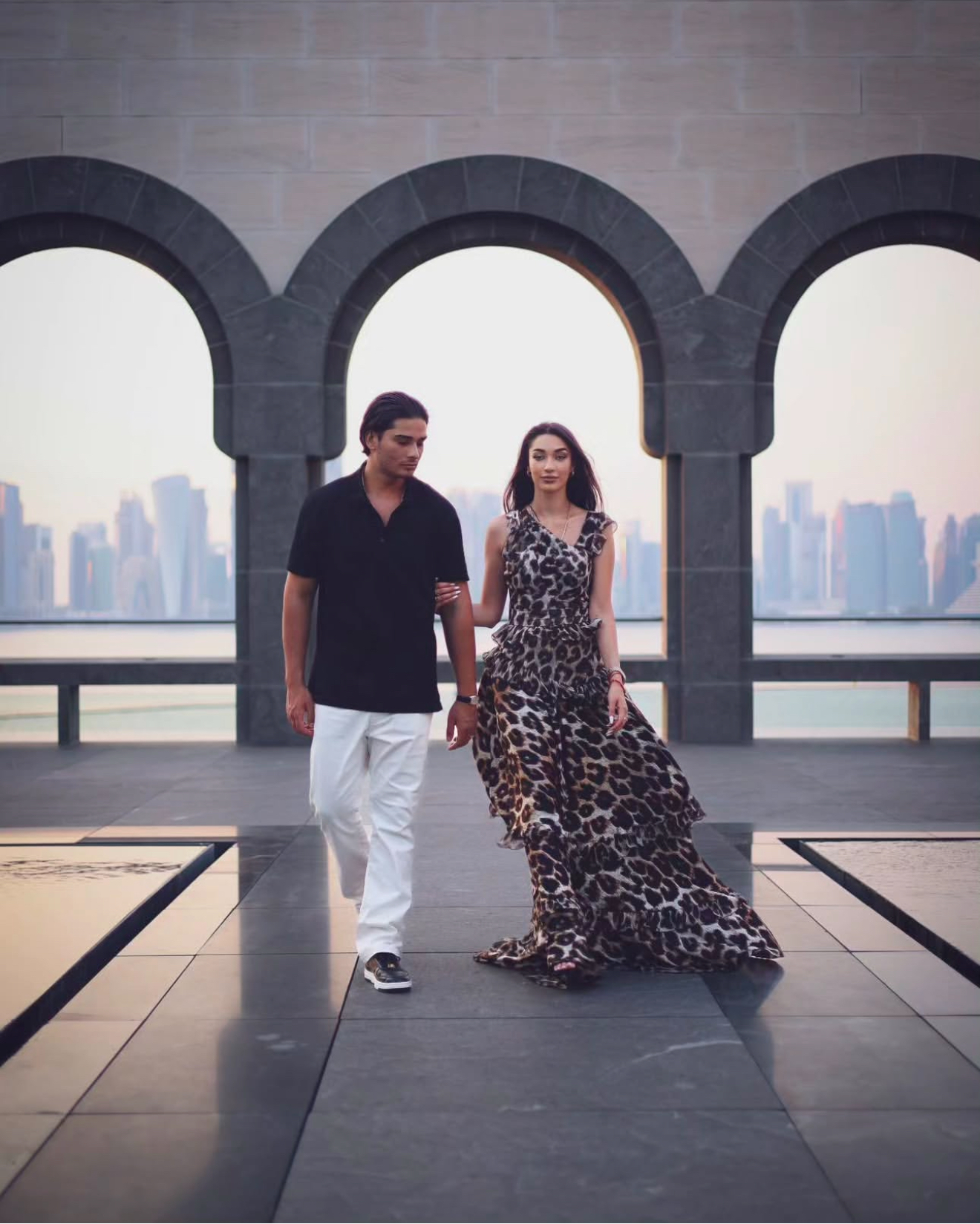 Couple portrait with Doha arches